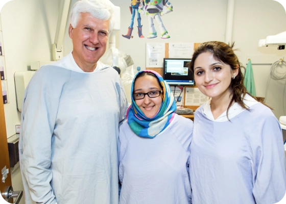 Three providers smile at the camera.