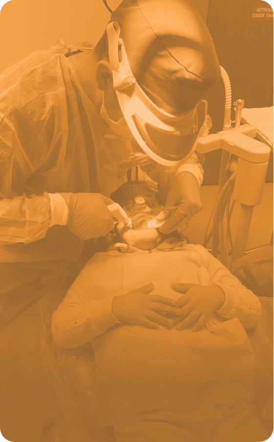 A young boy getting a dental procedure from a provider.